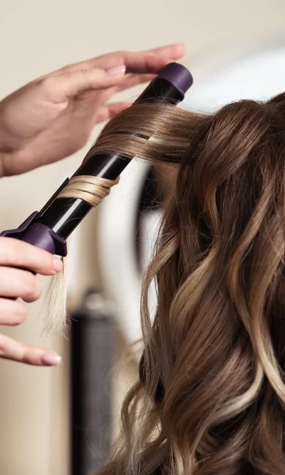 Hier werden mit einem Lockenstab, Waves gemacht für eine Hochzeit beim Coiffure Piazza.
